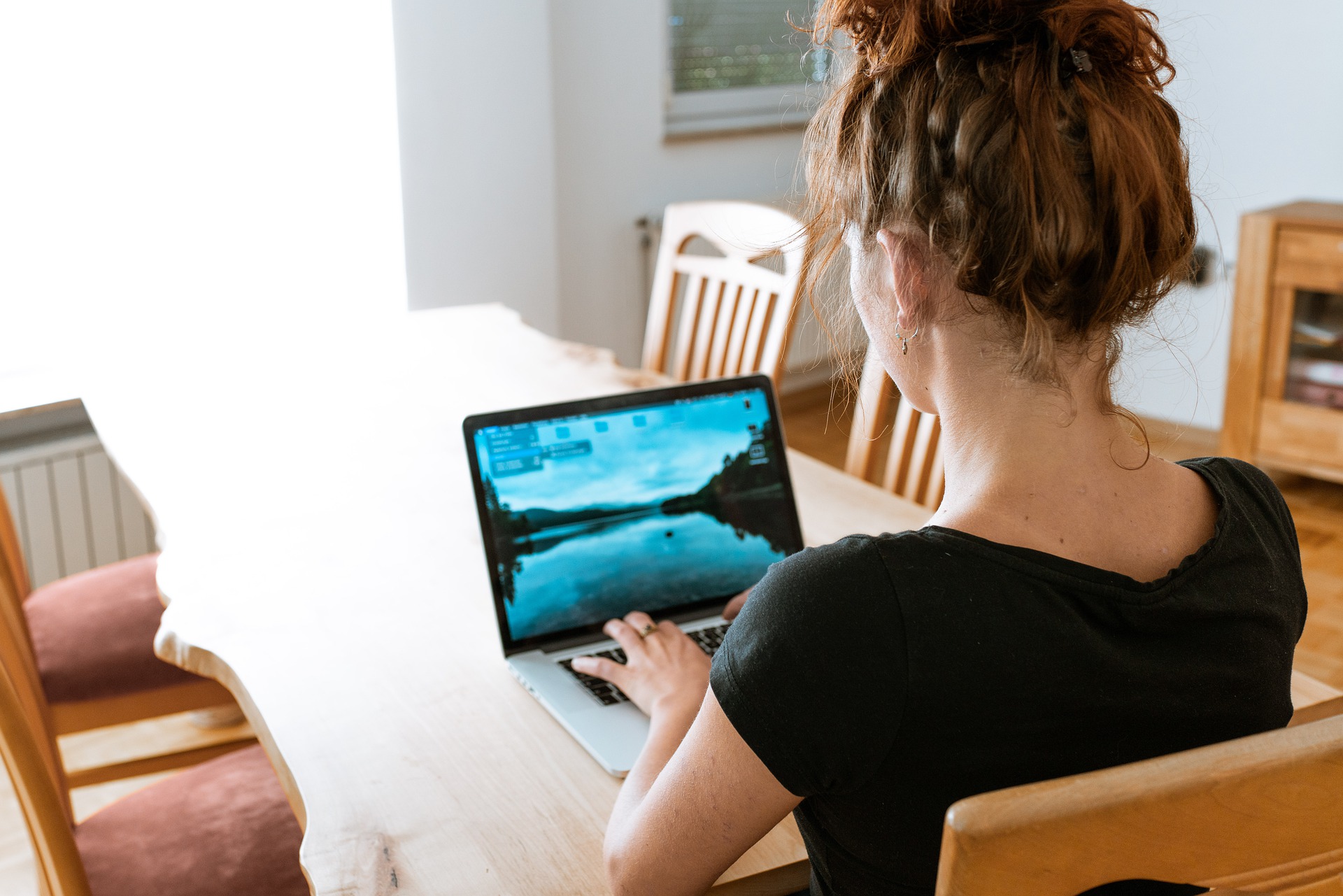 Woman making filings on laptop.