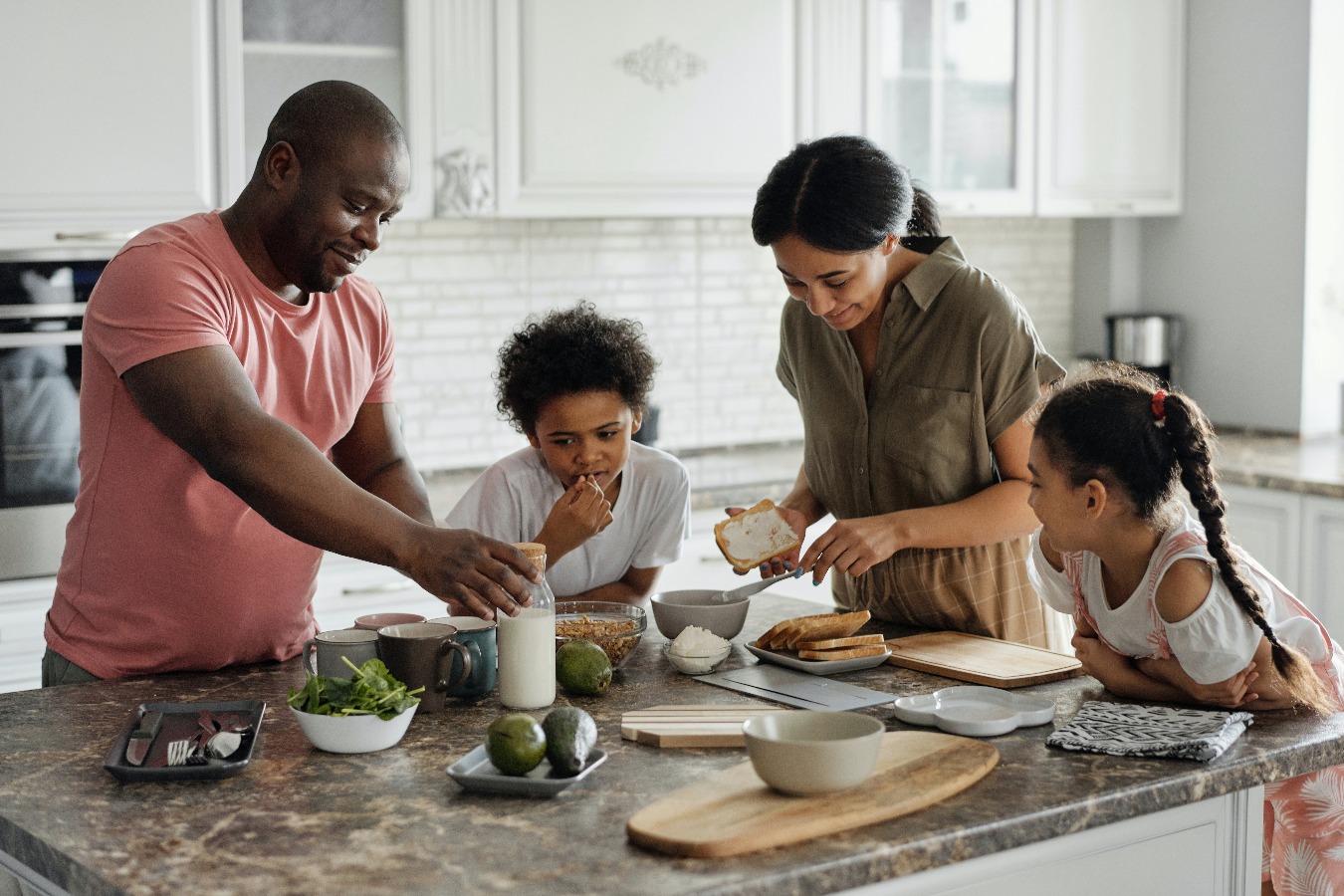 Family gathered around kitchen island.