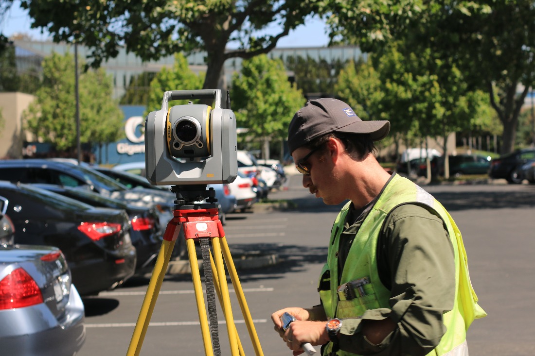Man in hi-viz vest using a transit.