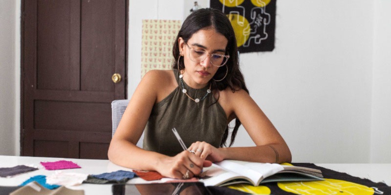 Woman working on fabric designs.