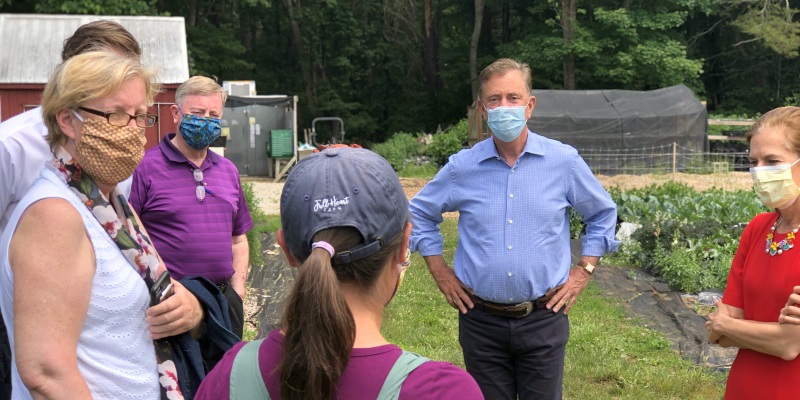 Governor Lamont speaks with people at a farm in Ledyard