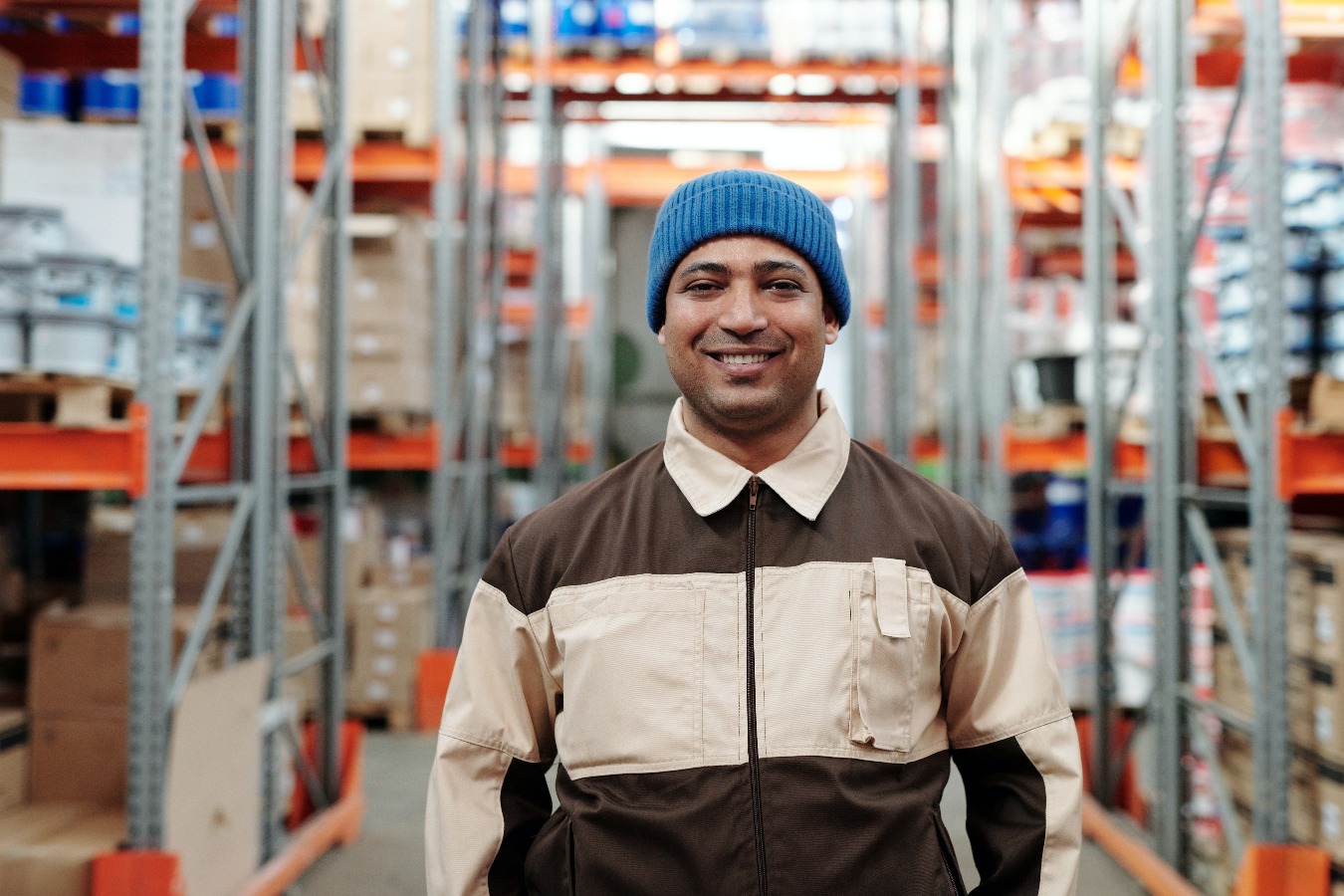 Man smiling in warehouse.
